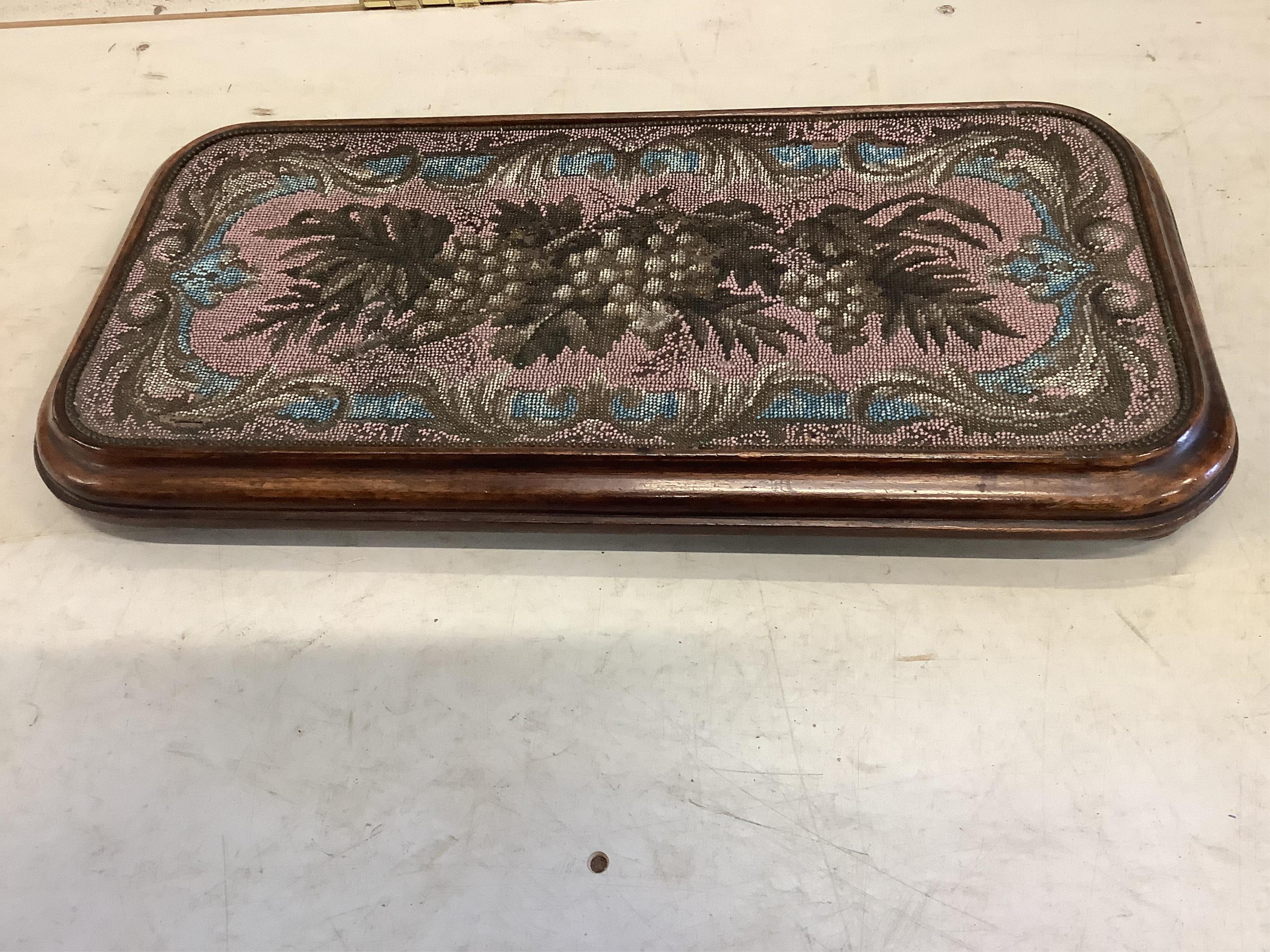 A Victorian rectangular beadwork stand, width 55cm, an Edwardian inlaid tea tray and a fret cut wall mirror. Condition - good